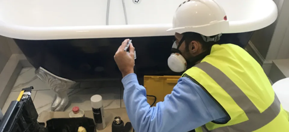 Surface Doctor technician working on a bath