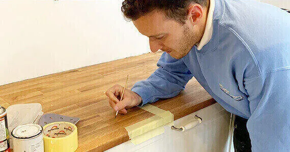 Surface Doctor technician repairing a wooden kitchen worktop