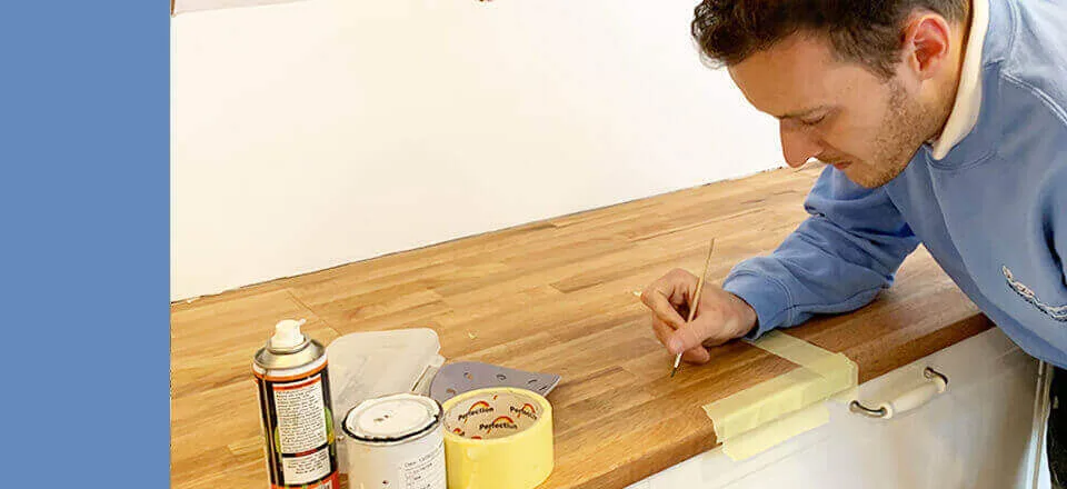 Surface Doctor technician repairing a wooden kitchen worktop